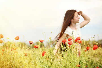 Wall Mural - Beautiful girl in poppy field