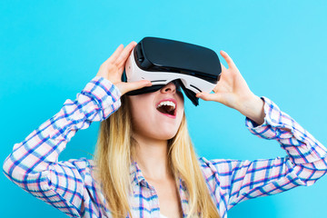 Wall Mural - Young woman using a virtual reality headset