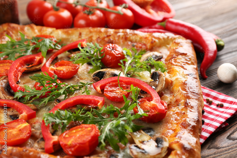 Freshly homemade pizza on wooden table closeup