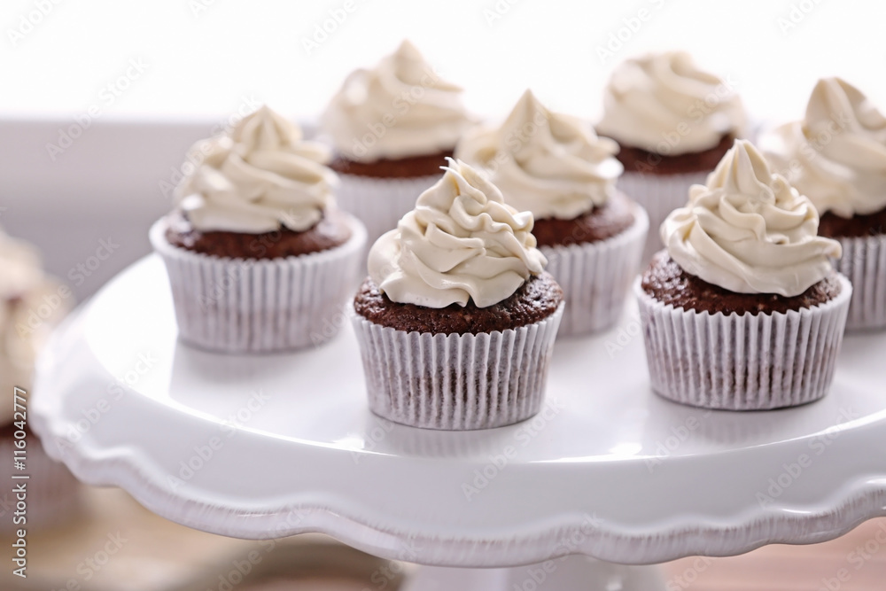Tasty cupcakes on stand