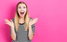 Happy Young Woman Posing On Pink Background