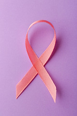 Poster - Pink ribbon symbol on light purple background