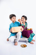 indian small brother and sister enjoying and celebrating Raksha Bandhan festival