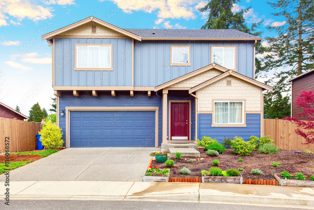 Nice curb appeal of blue house with front garden and garage with ...