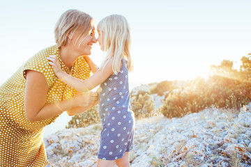 mom playing with child in sunlight