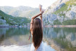 © ADDICTIVE STOCK - Young girls posing with white dress into a lake.