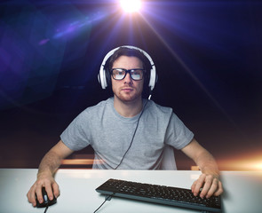 man in headset playing computer video game