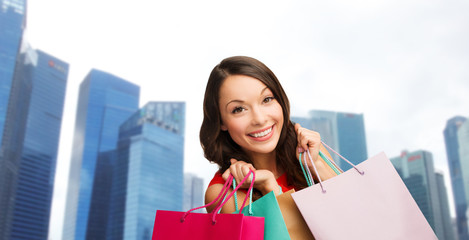 Canvas Print - happy woman with shopping bags over singapore city