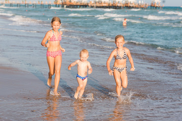 Wall Mural - Happy kids on the beach