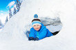 © Sergey Novikov - Little boy crawl through snow tunnel in park