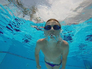 boy diving into a swimming pool