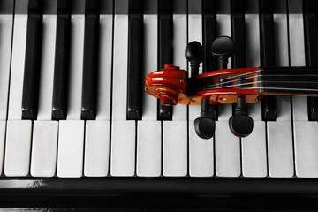 Sticker - Violin neck lying on piano keys, close up