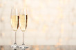 Two champagne glasses on light background