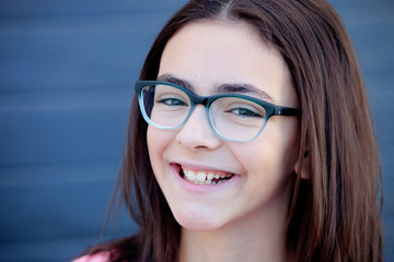 Wall Mural - Pretty preteenager girl with glasses outside