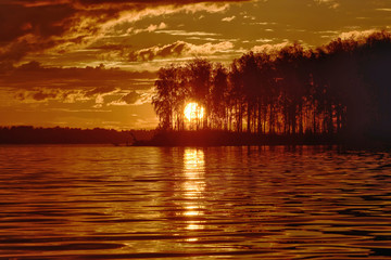 Wall Mural - landscape setting sun on the background of the river.