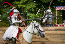 Armored Knights On Horseback Charging In A Joust Right After The Impact . Jousting Is A Martial Game Or Hastilude Between Two Horsemen Wielding Lances With Blunted Tips, Often As Part Of A Tournament.
