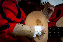 Closeup Of The Hands Of A Medieval Court Musician Playing The Lute