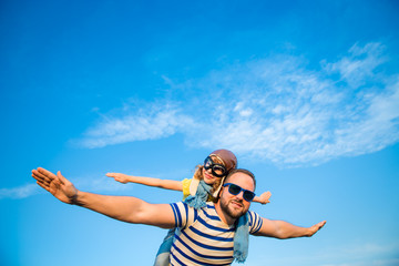 Kid and father playing outdoors