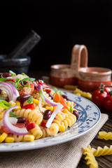 Wall Mural - Mexican pasta salad with red bean, corn, tomato, onion and pepper