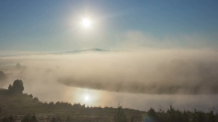 Wall Mural - timelapse landscape with sunrise and strong fog over river