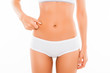 © deagreez - Close up portrait of fit woman checking fat on her belly