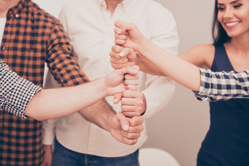 Poster - close-up photo of businesspeople  putting their fist on top of e