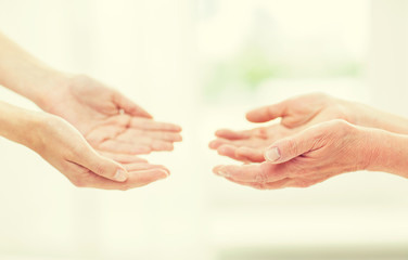 Wall Mural - close up of senior and young woman hands