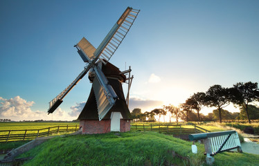 Fototapete - old Dutch windmill at sunrise