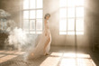 © kharchenkoirina - Lady in white vintage dress standing in a large spacious room , fantastic shot, fairytale princess turned into smoke , trendy toning , creative computer colors.