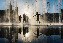 Children Playing In A Fountain
