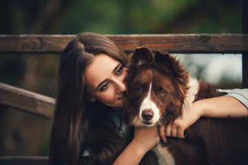 girl hugging a dog