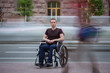 © realstock1 - The invalid man sit in the wheel chair in the crowd stream at the pavement