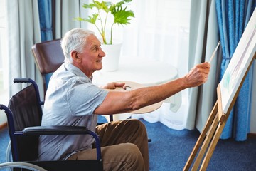 Wall Mural - senior man using brush and easel