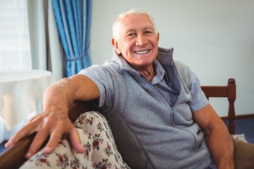 Wall Mural - senior man sitting on a couch