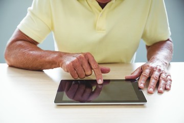 Wall Mural - senior man using a digital tablet