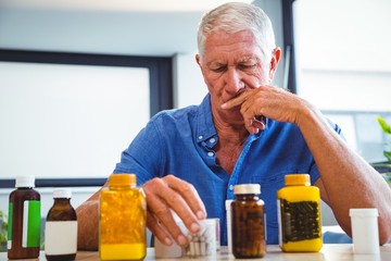 Wall Mural - senior man holding medicine