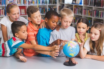 Poster - School kids looking at globe in library