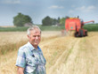 © Budimir Jevtic - Farmer on field with combine harbester