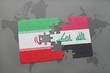 puzzle with the national flag of iran and iraq on a world map background.