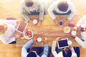 Canvas Print - close up of business team drinking coffee on lunch