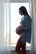 © Syda Productions - happy pregnant woman with big bare tummy at home