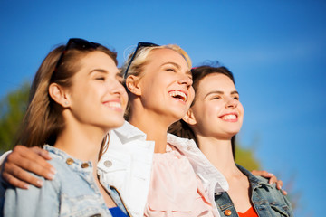 Poster - happy women or teenage girls hugging outdoors