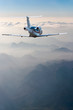 perspective view of jet airliner in flight with mountains background