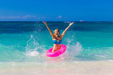 Fototapeta Łazienka - Young beautiful girl in bikini swims in a tropical sea on a rubb