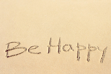 Wall Mural - Be happy handwritten on the sandy beach