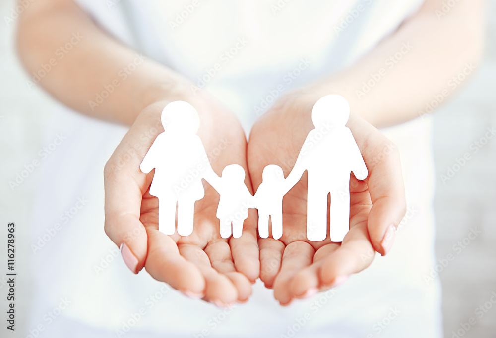 Female hands with paper family. Family love concept