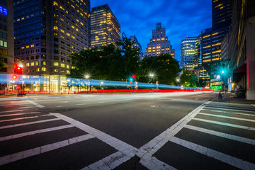 An intersection and crosswalks in the Financial District at nigh