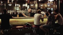 People Sitting And Relaxing At The Bar, Bartender Clears The Bar Counter