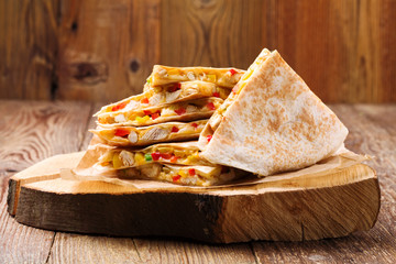 Quesadilla with chicken, served with guacamole or salsa sauce.