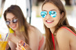 © patramansky - two attractive young women drinking cocktails